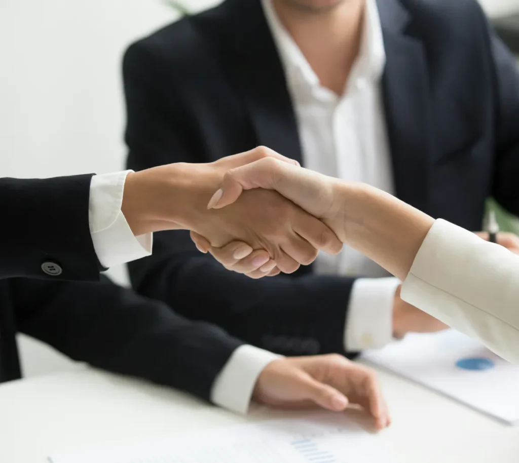 Business professionals shaking hands during a meeting