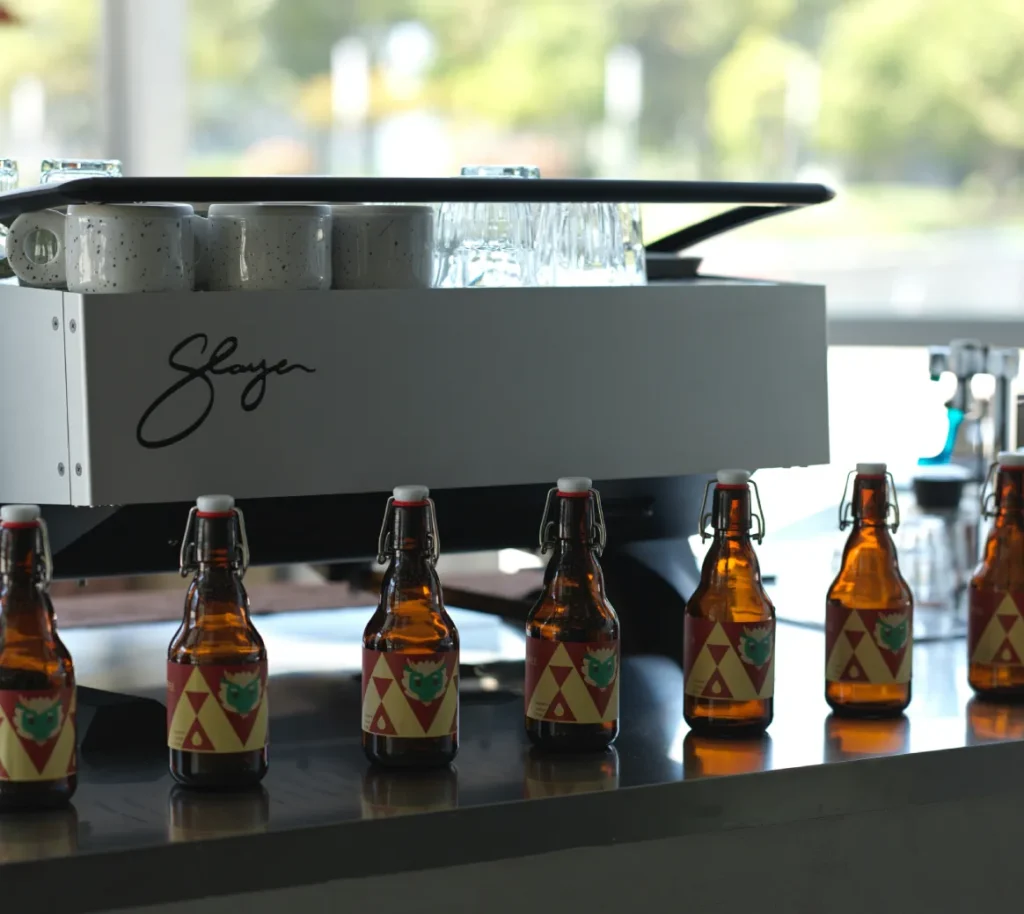 Bottled beverages lined up on a cafe counter