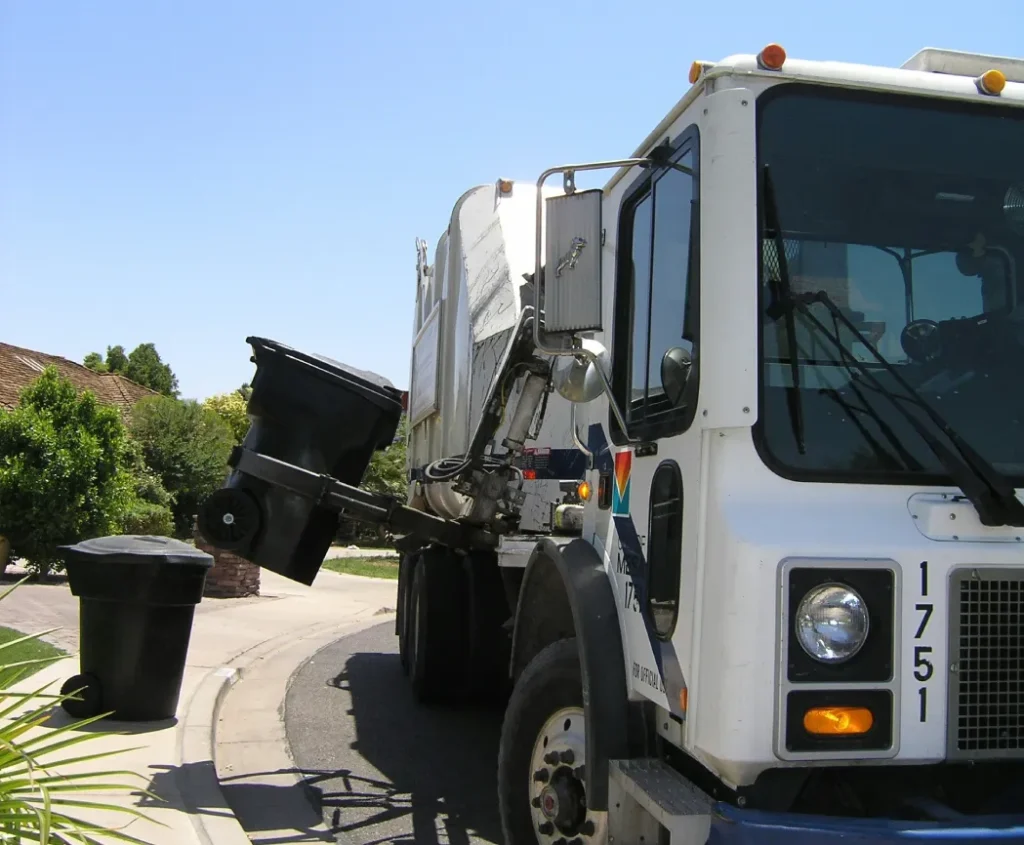 Garbage truck lifting a curbside waste bin