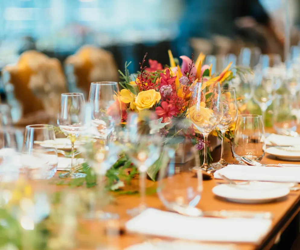 Event dining table set with glassware and a floral centerpiece
