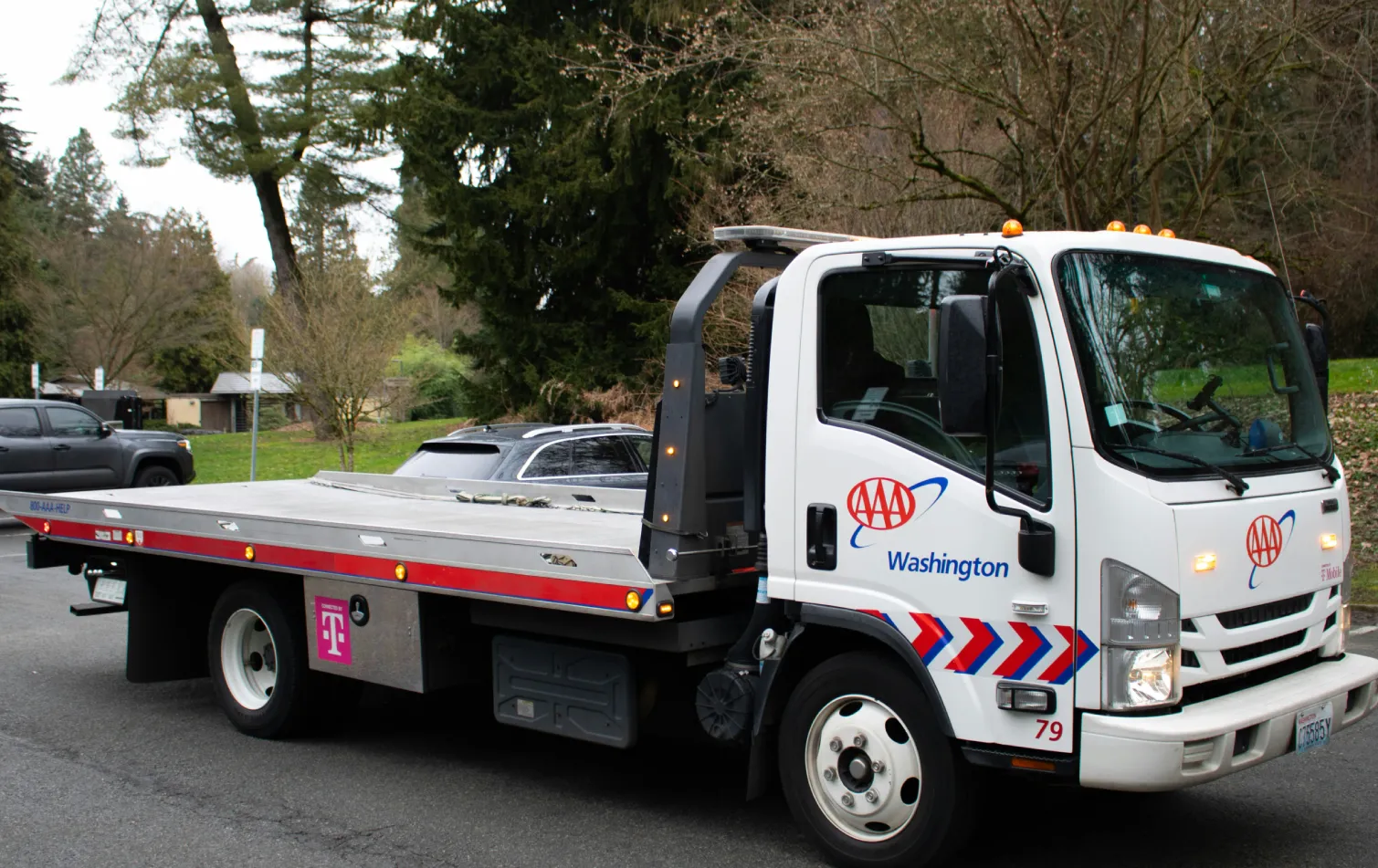 AAA flatbed tow truck parked beside a road